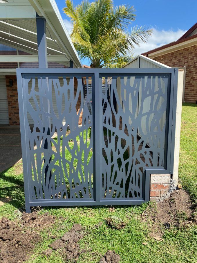 A Fence with A Design on It Is in Front of A House — Lifestyle Aluminium Fabrication In Albion Park Rail, NSW