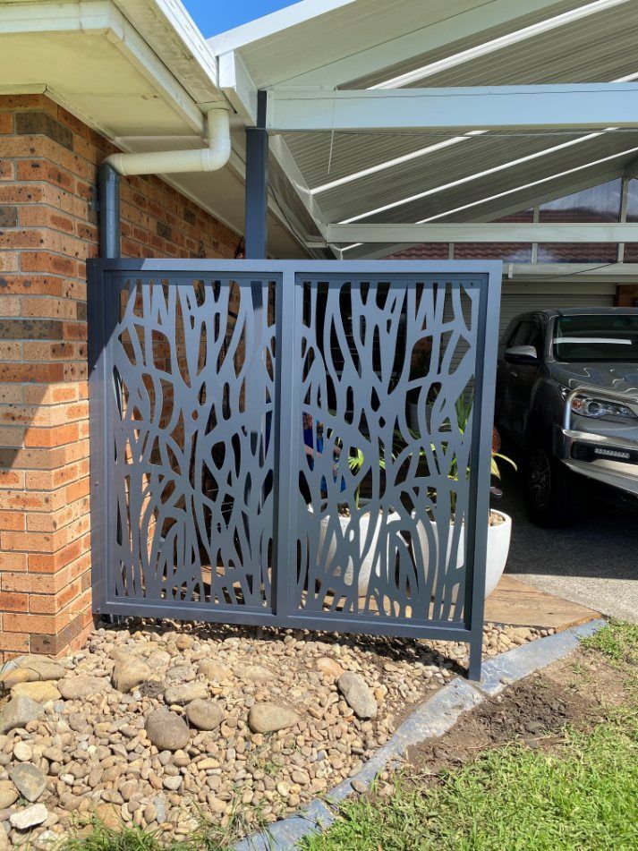 A Car Is Parked Under a Canopy in Front of A House — Lifestyle Aluminium Fabrication In Albion Park Rail, NSW