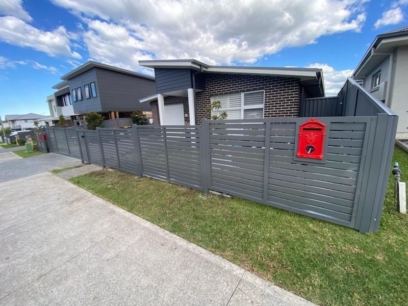 A House With a Fence and a Red Mailbox in Front of It — Lifestyle Aluminium Fabrication In Dapto, NSW