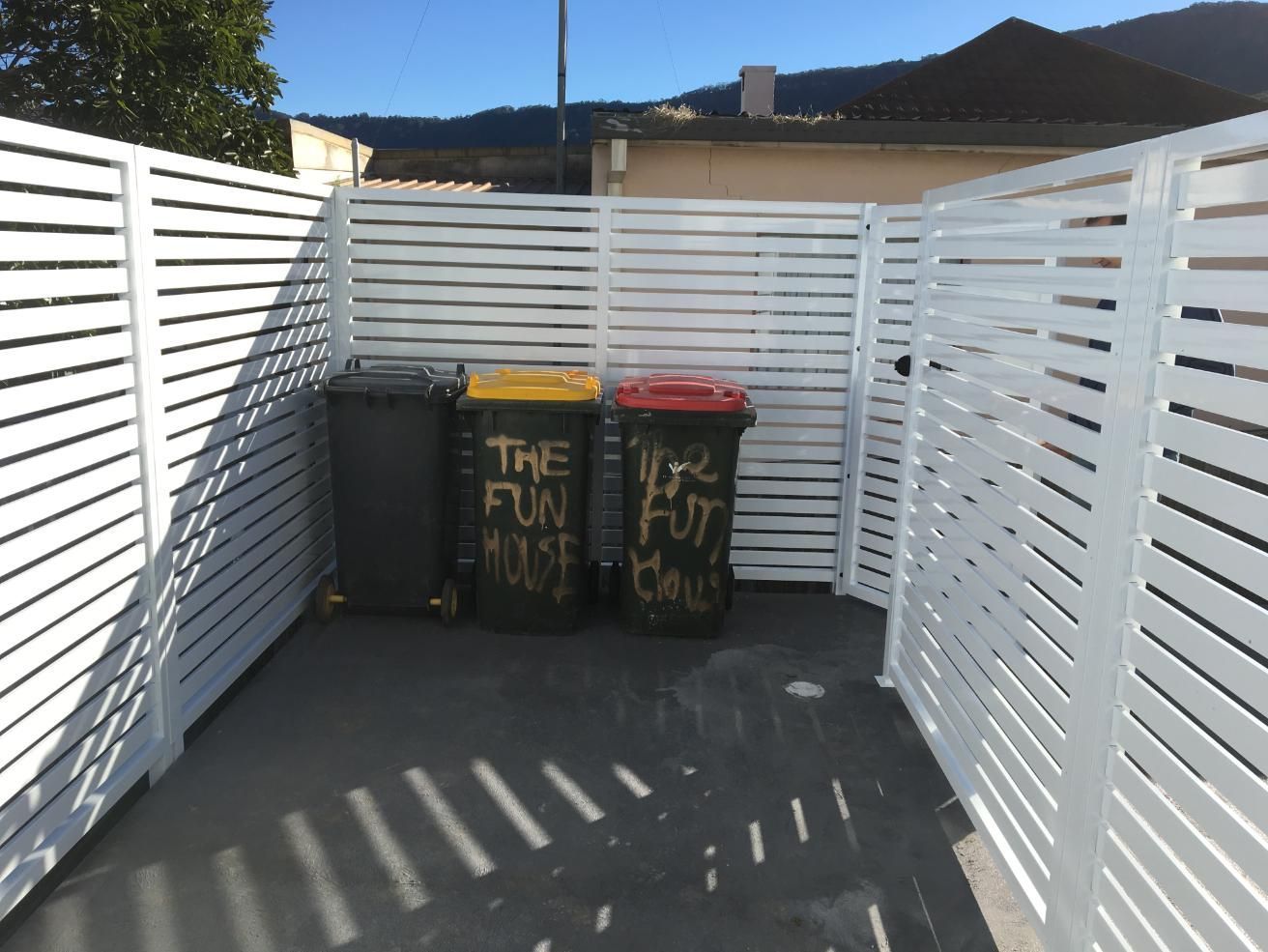 Three Trash Cans Are Behind a White Fence That Says the Fun Must End — Lifestyle Aluminium Fabrication In Kiama, NSW