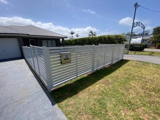A White Fence With a Mailbox in Front of a House — Lifestyle Aluminium Fabrication In Shellharbour, NSW