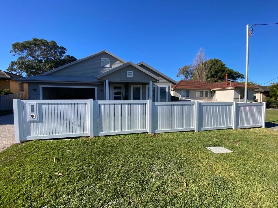 A House With a White Fence in Front of It — Lifestyle Aluminium Fabrication In Dapto, NSW
