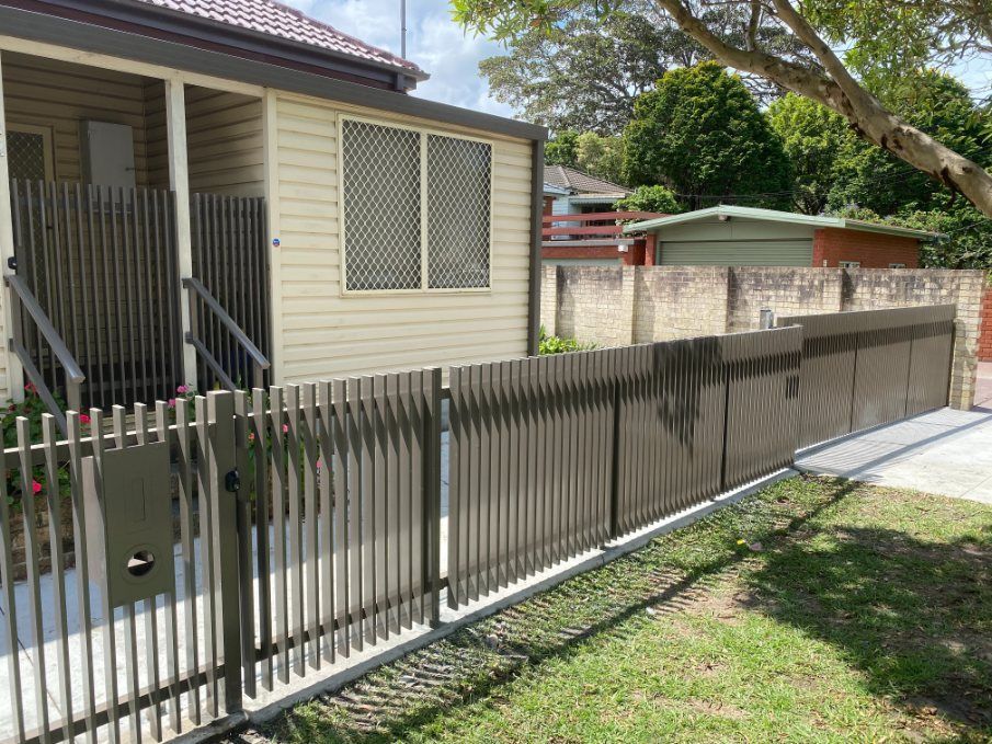 A House with A Fence and A Mailbox in Front of It — Lifestyle Aluminium Fabrication In Albion Park Rail, NSW