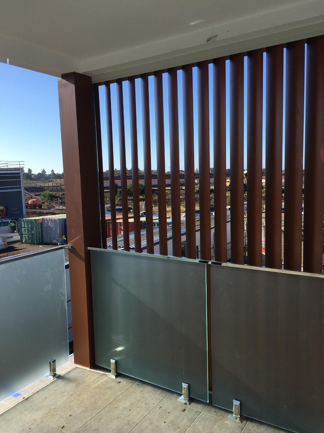 A Balcony With A Fence And A View Of A City — Lifestyle Aluminium Fabrication In Shellharbour, NSW