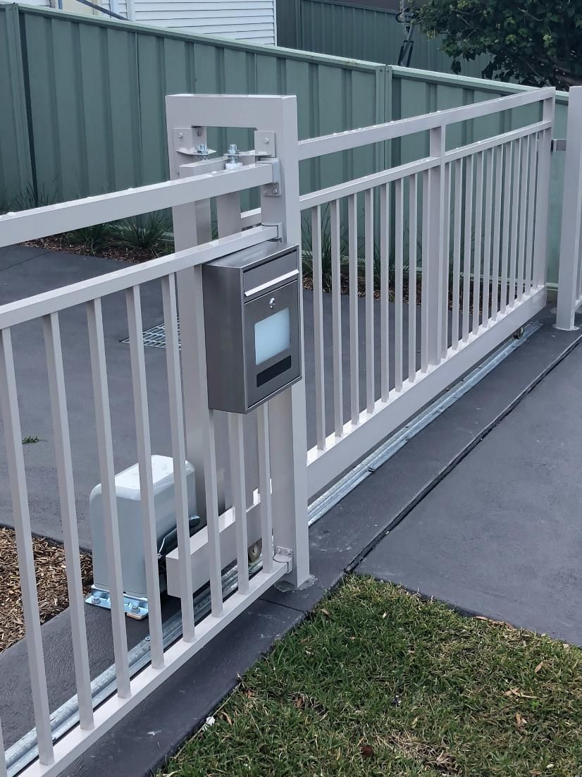 A White Fence With a Mailbox Attached to It — Lifestyle Aluminium Fabrication In Shellharbour, NSW