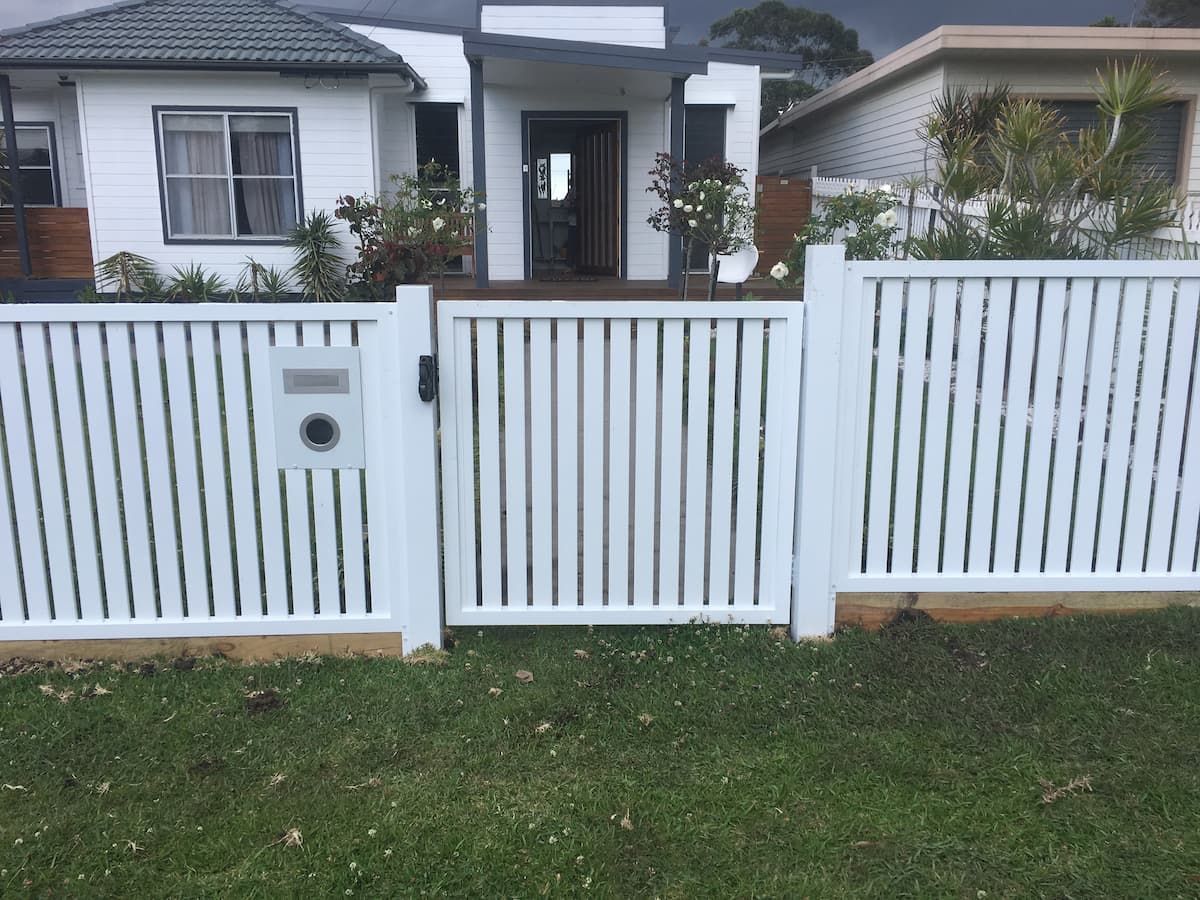 A White Fence with A Gate in Front of A House — Lifestyle Aluminium Fabrication In Dapto, NSW