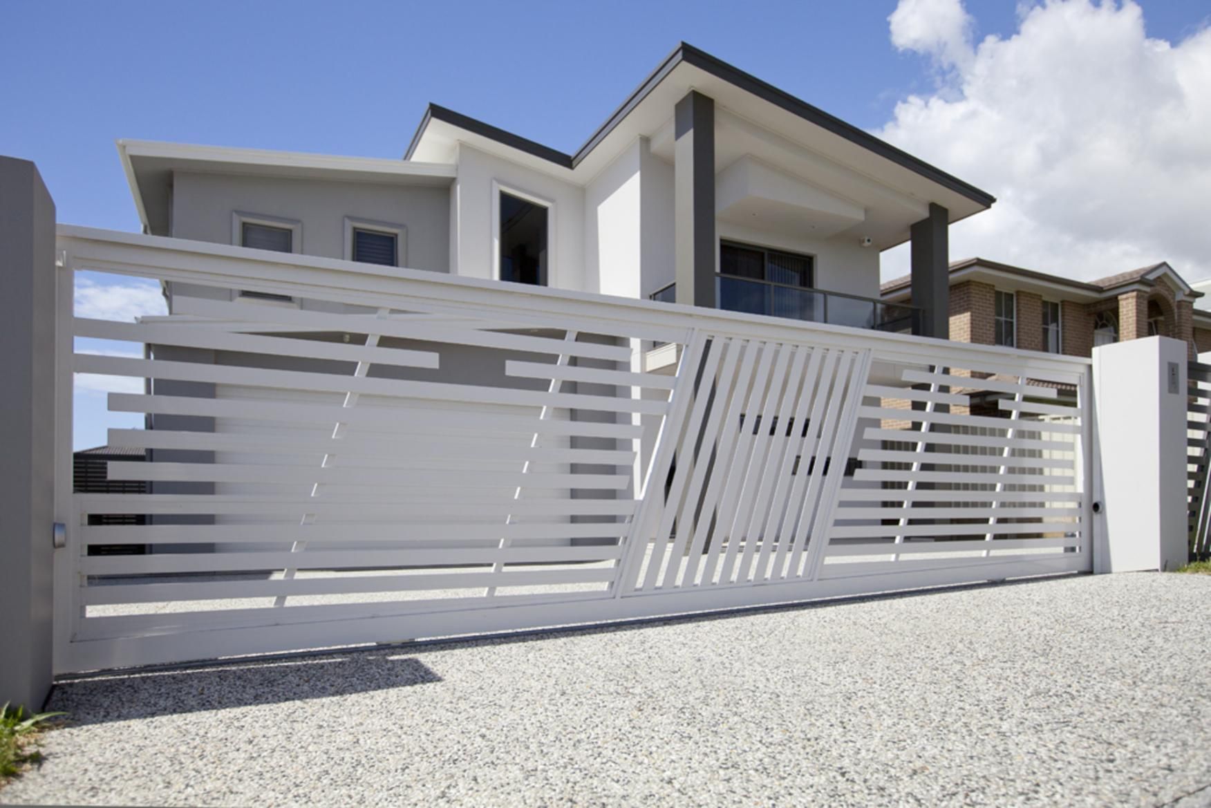 A Large White House With A Sliding Gate In Front Of It  — Lifestyle Aluminium Fabrication In Albion Park Rail, NSW