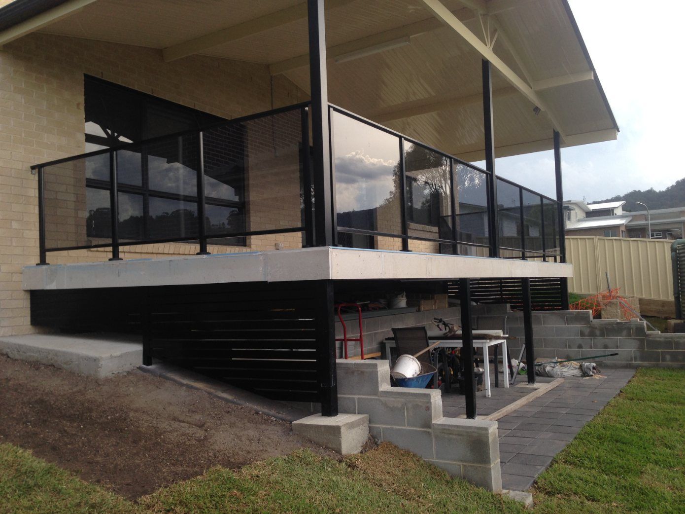 A House with A Balcony and Stairs Leading up To It — Lifestyle Aluminium Fabrication In Albion Park Rail, NSW