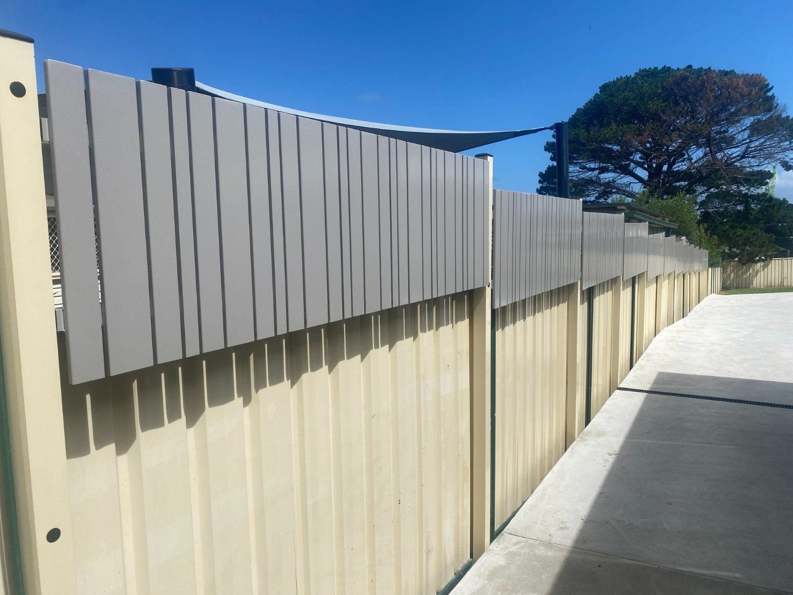 A Balcony with White Shutters and A Glass Railing — Lifestyle Aluminium Fabrication In Albion Park Rail, NSW
