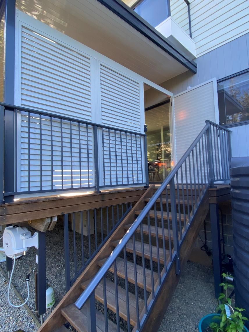 A Set of Wooden Stairs Leading Up to a Balcony — Lifestyle Aluminium Fabrication In Shellharbour, NSW