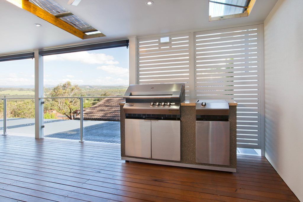 A Kitchen with A Grill and Cabinets on A Wooden Floor — Lifestyle Aluminium Fabrication In Albion Park Rail, NSW