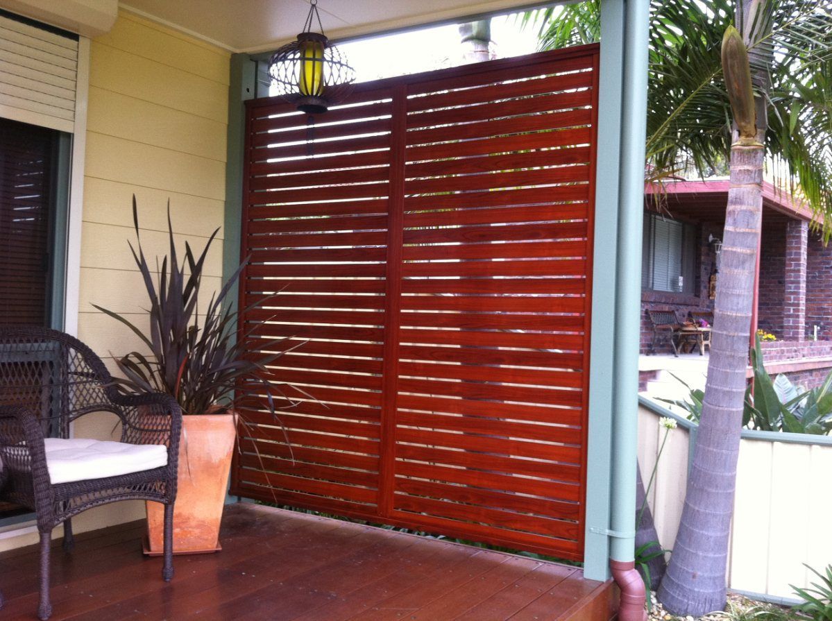 A Porch with A Wooden Fence and Potted Plants — Lifestyle Aluminium Fabrication In Albion Park Rail, NSW