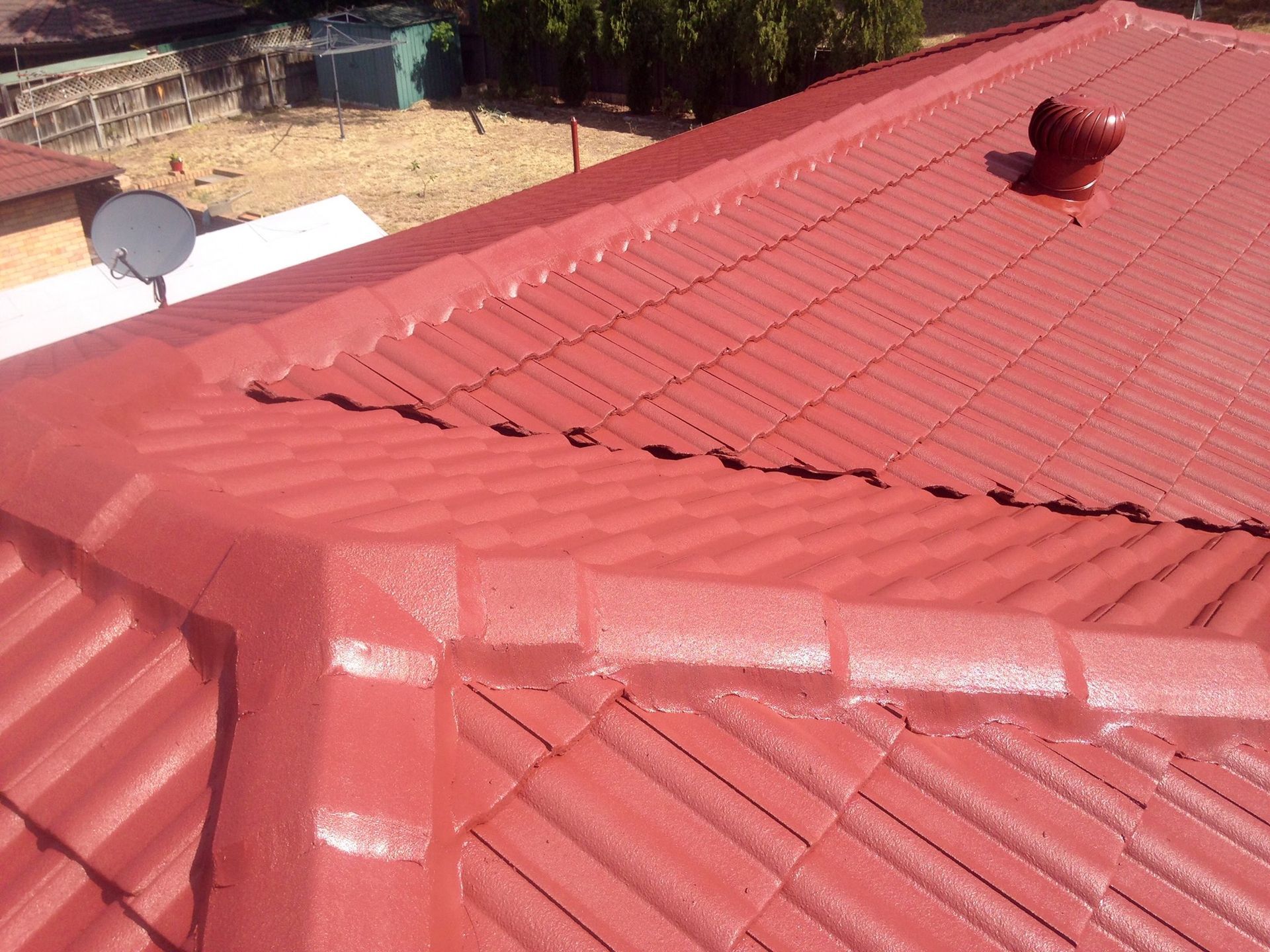 A Red Roof With A Satellite Dish On Top Of It — In-Time Roofing In Newcastle, NSW