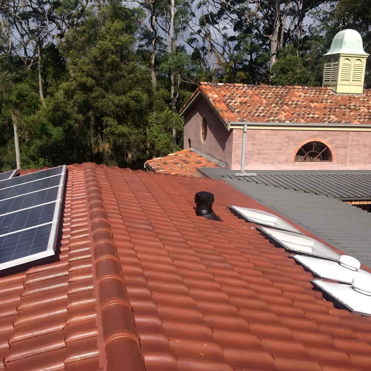 A Roof With A Lot Of Tiles And Solar Panels — In-Time Roofing In Newcastle, NSW