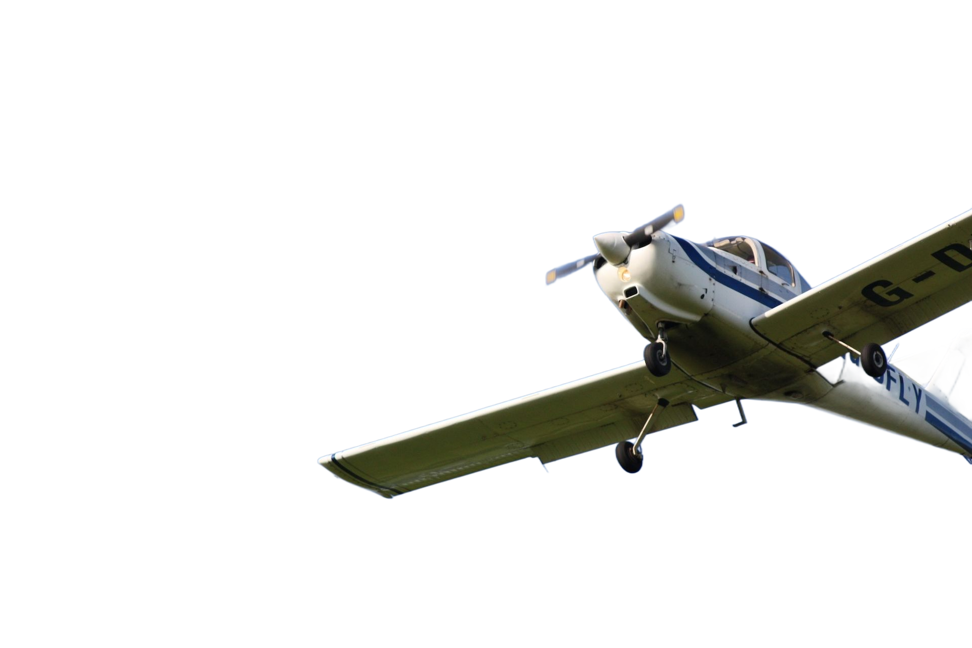 Small training aircraft flying against a clear blue sky, illustrating early flight training stages when people ask how long does it take to become a pilot.