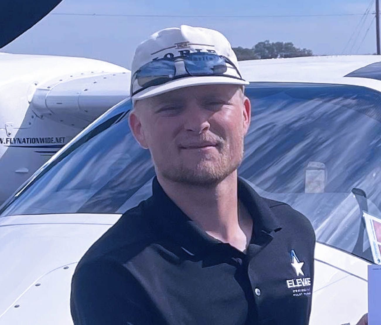 Man standing beside multi-engine aircraft for training testimonial.