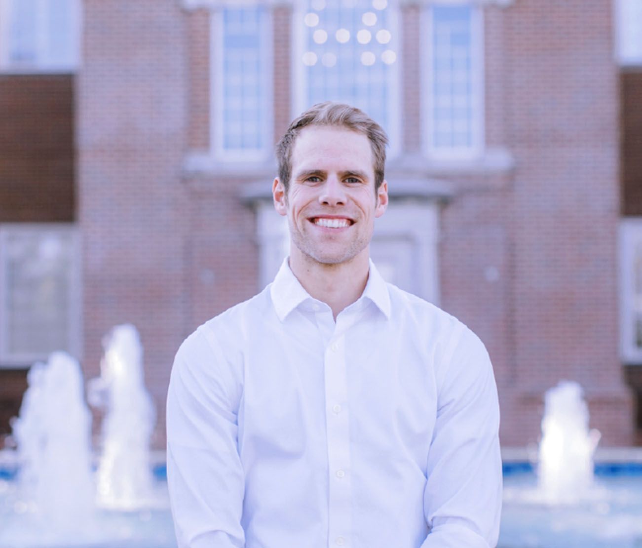 Student standing outside building for accelerated program testimonial.