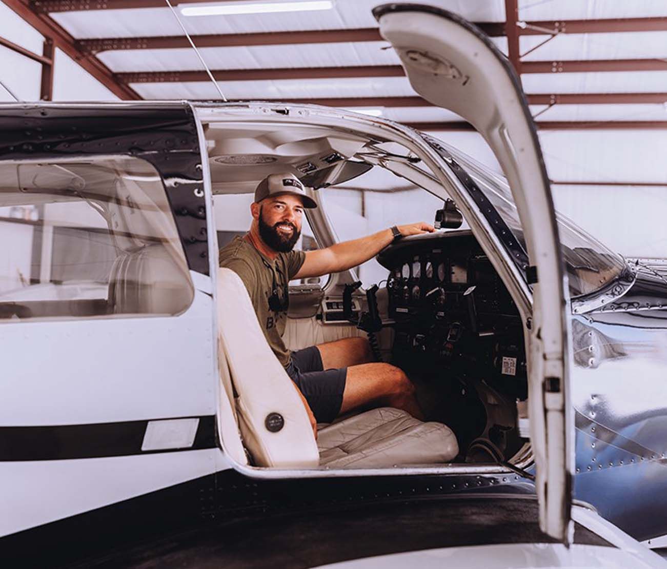 Student sitting inside aircraft cockpit during training session.