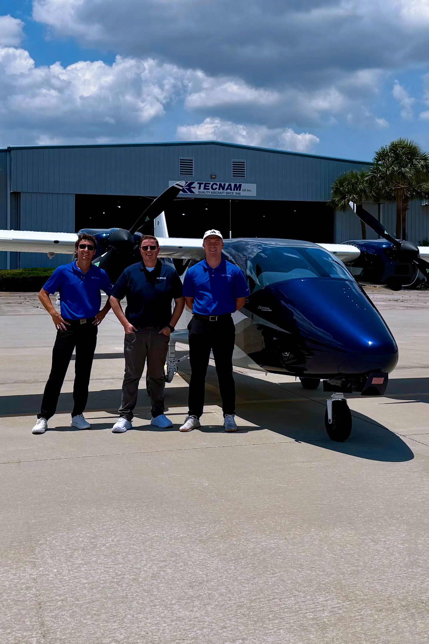 Flight school facility with aircraft parked outside under partly cloudy sky.
