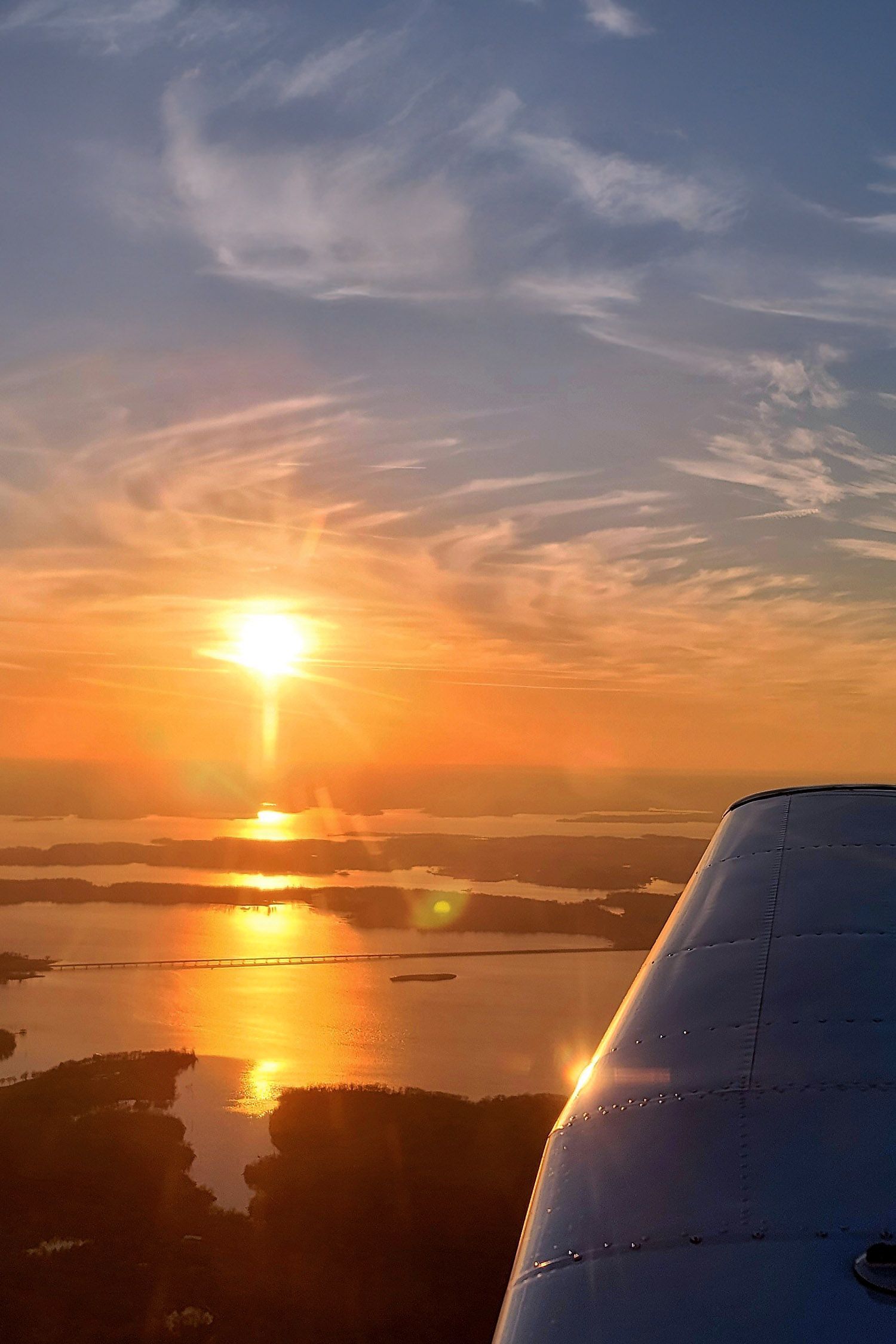 Sunset sky viewed from aircraft window during flight.