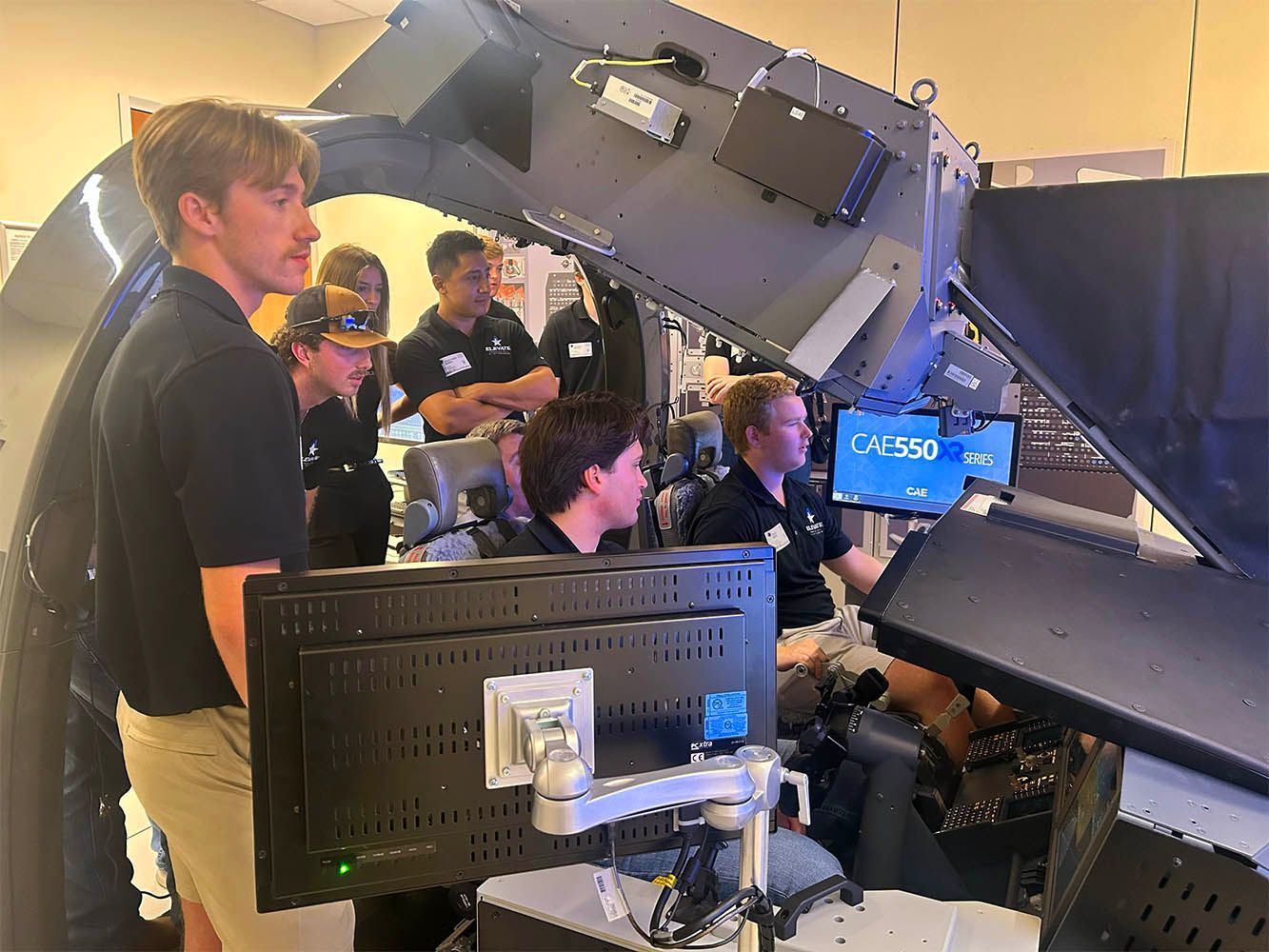 Technicians inspecting aircraft components during maintenance inside the hangar.