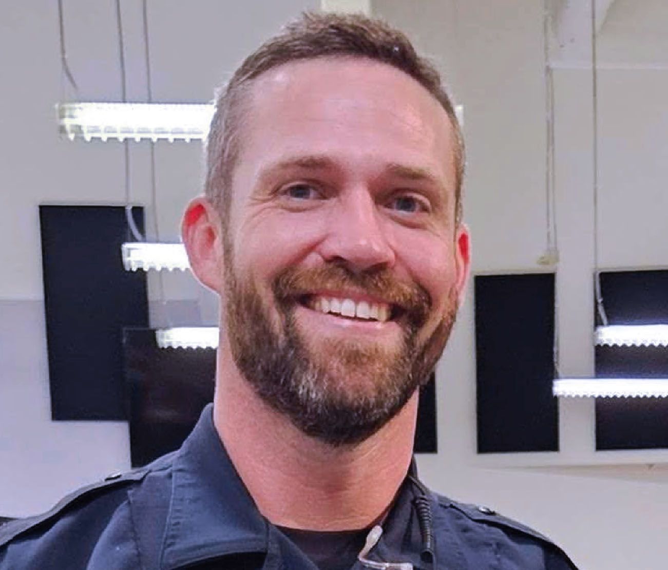 Smiling student standing indoors for aviation training testimonial.