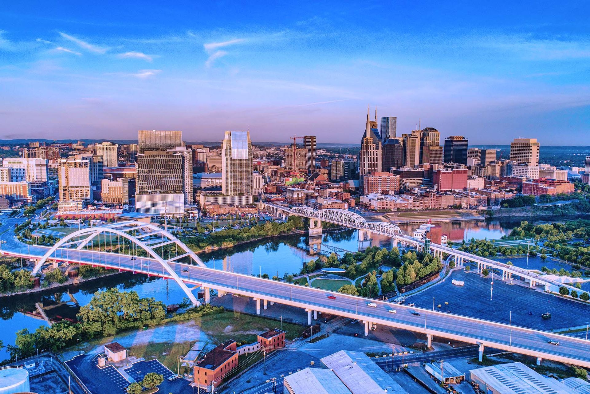 Aerial view of Nashville skyline with bridges and cityscape.