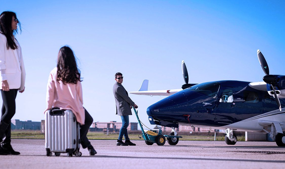 Students walking near twin-engine training aircraft on the ramp.