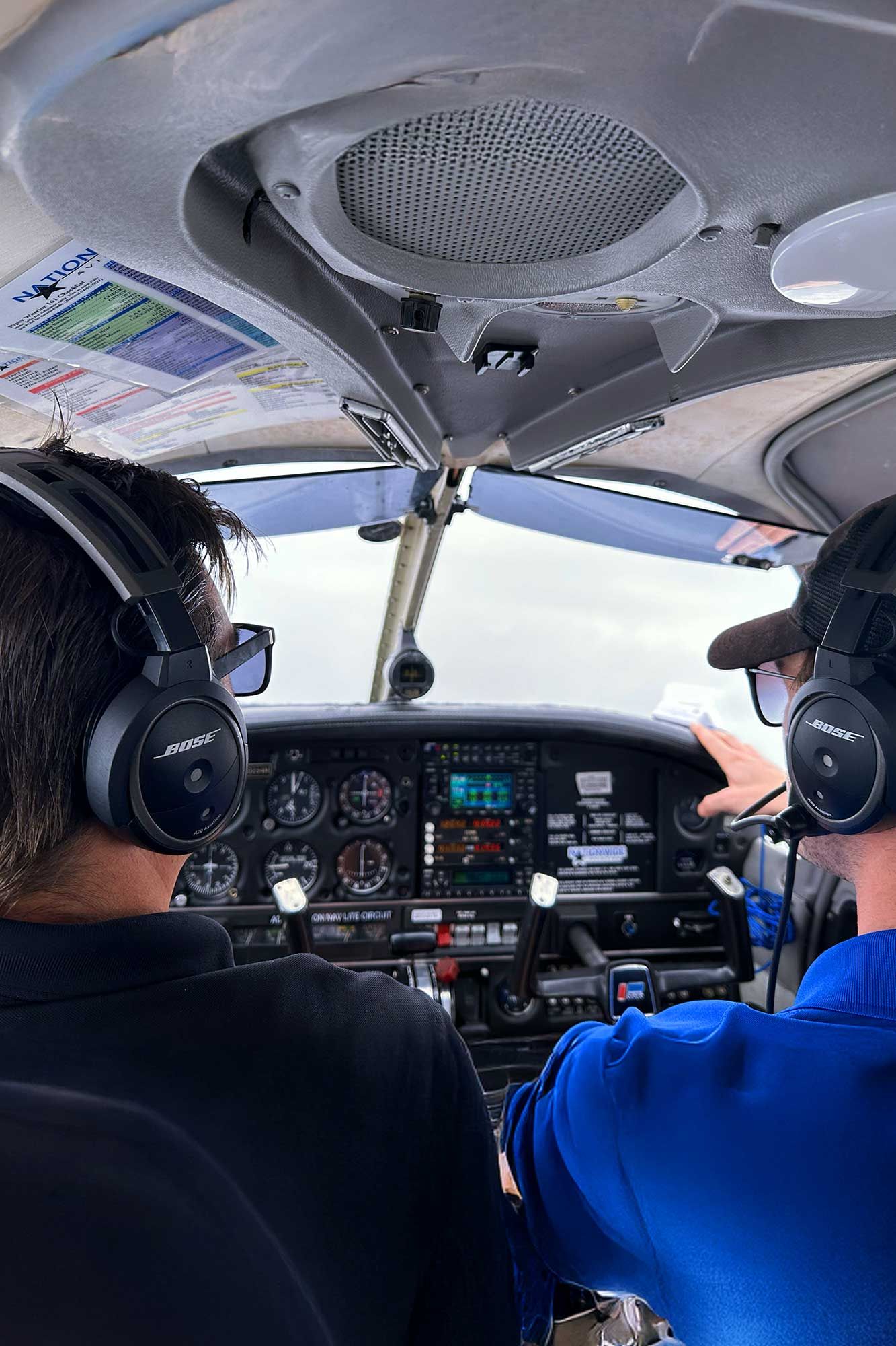Close-up view of aircraft overhead panel and ventilation system.
