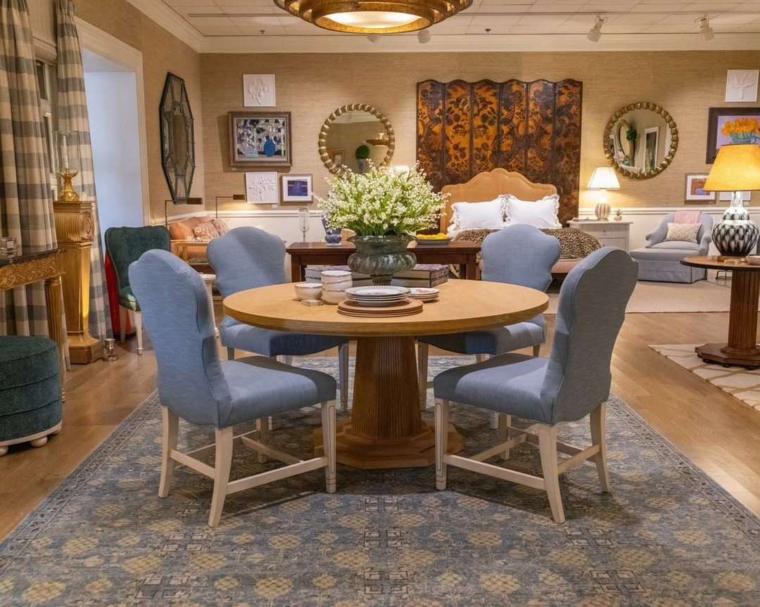 A dining room with a round table and blue chairs