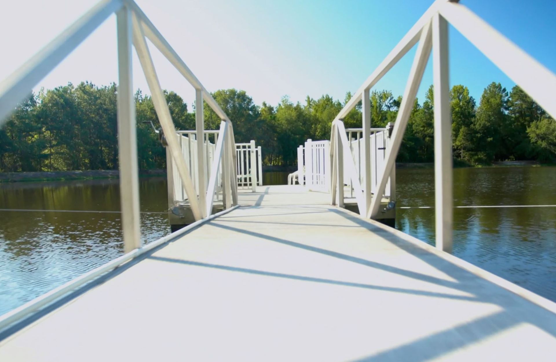A bridge over a body of water with trees in the background