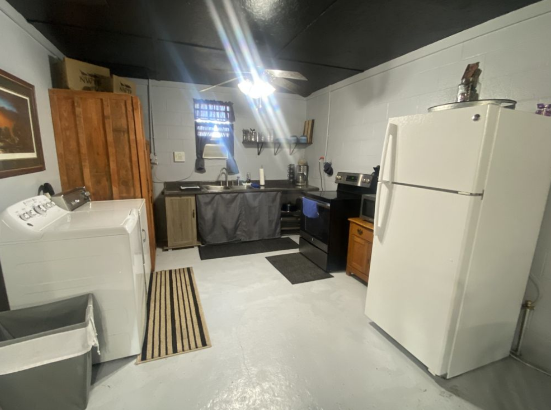 A kitchen with a refrigerator , stove , and sink.