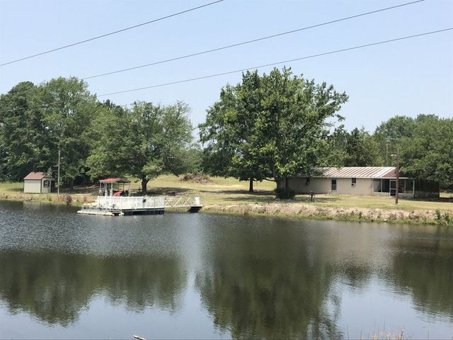 A boat is docked in the middle of a lake.