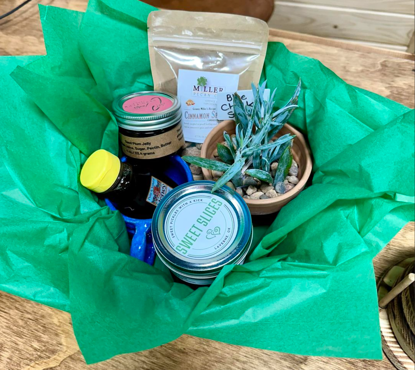 A basket filled with bottles , jars , and plants on a table.