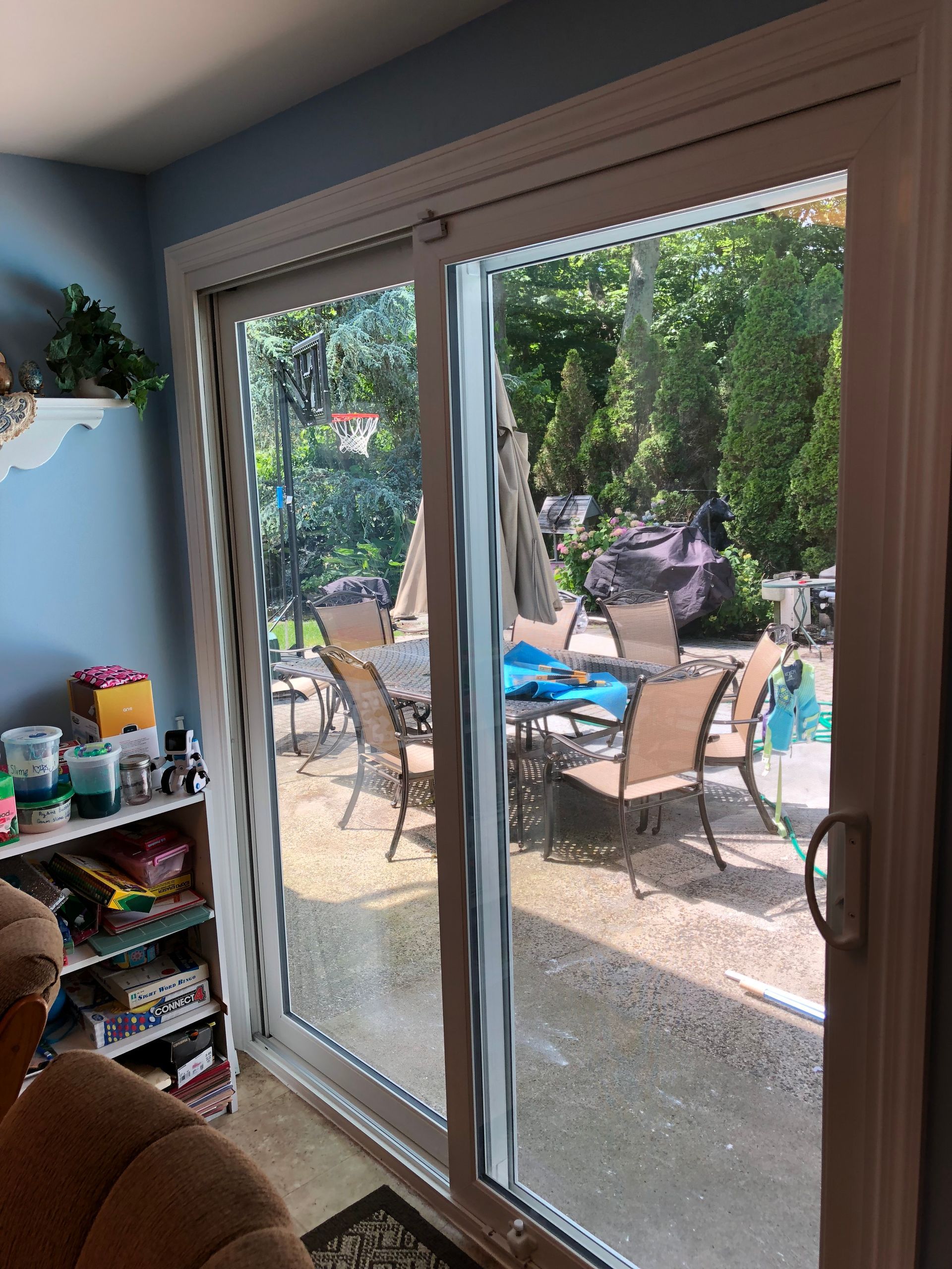 A living room with a sliding glass door leading to a patio.