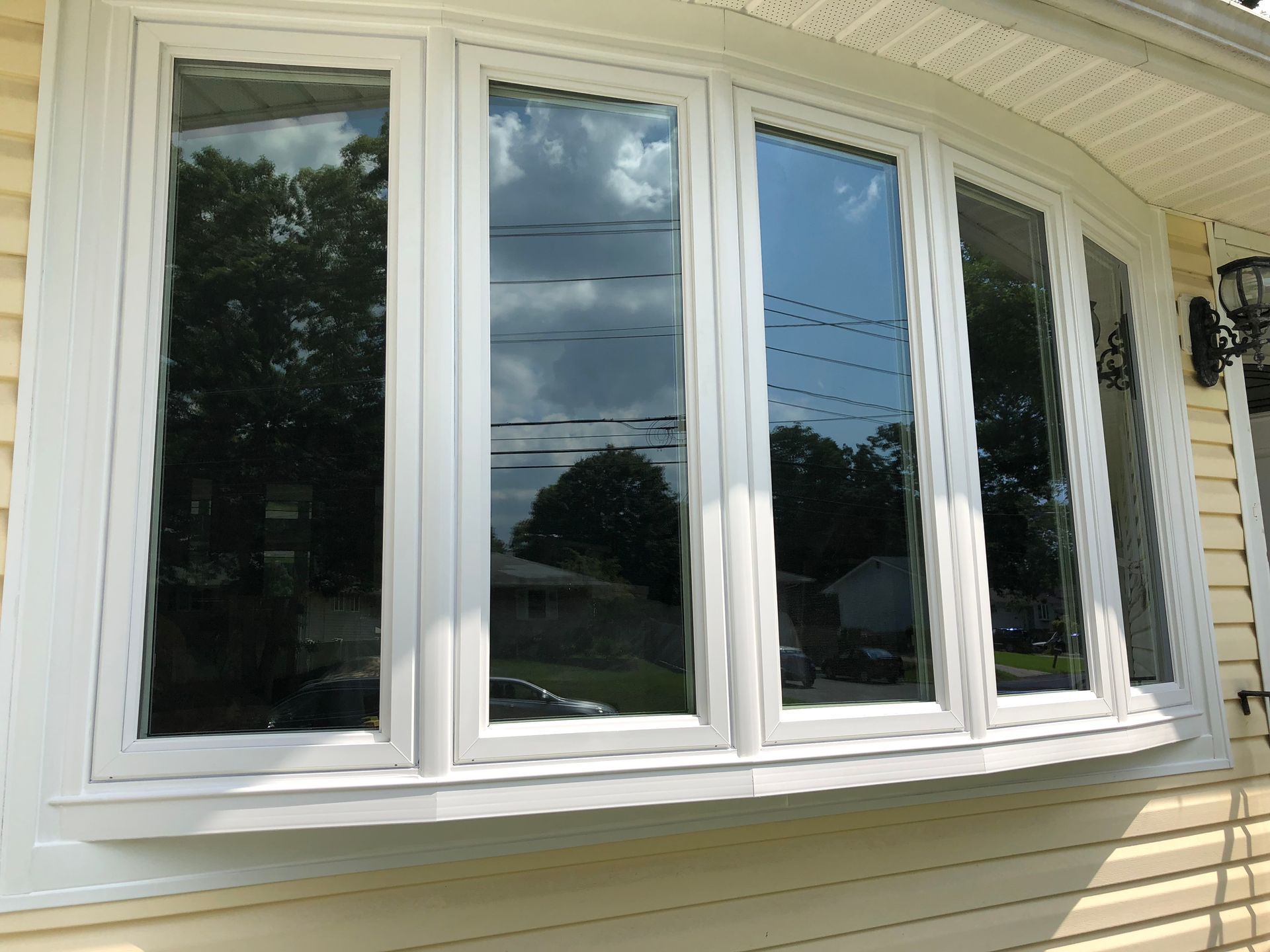 A white window on the side of a house