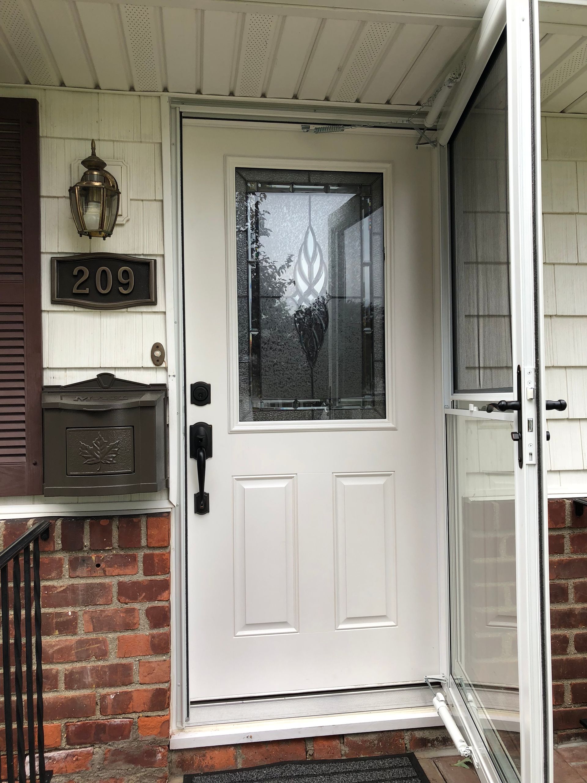 The front door of a house with the number 209 on it.