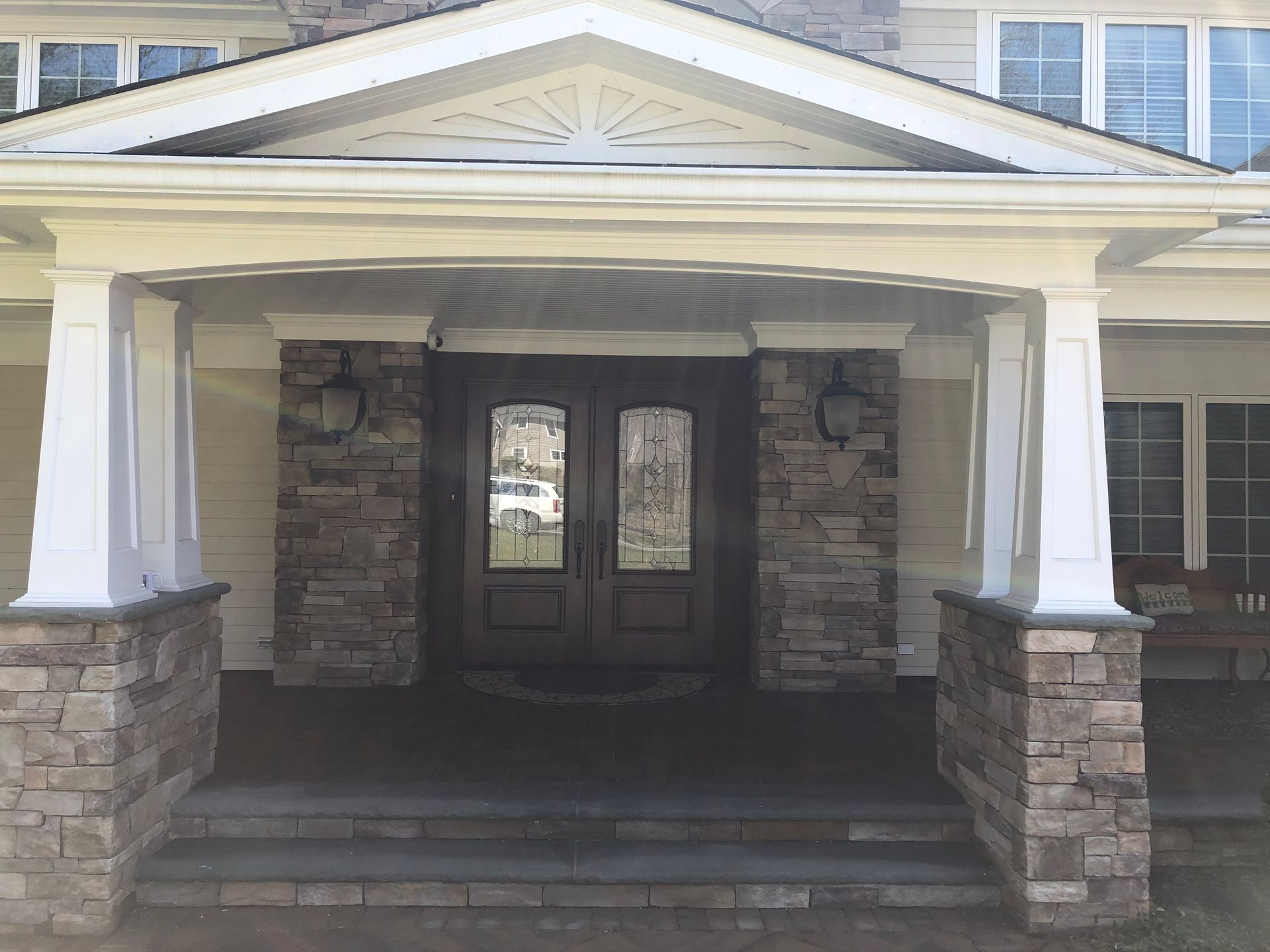 The front of a house with a porch and stairs