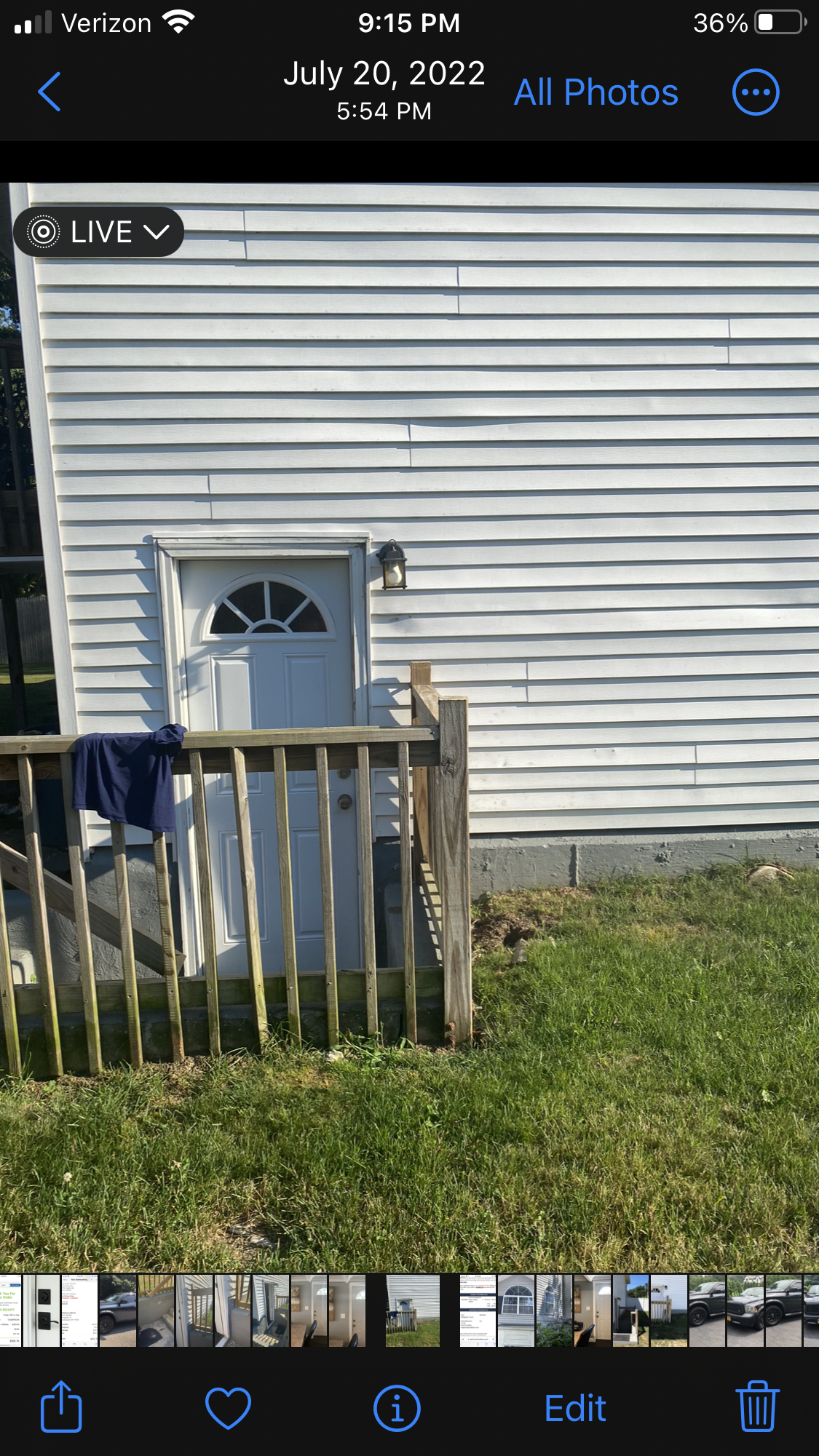 A phone screen shows a picture of a white house with a wooden deck.