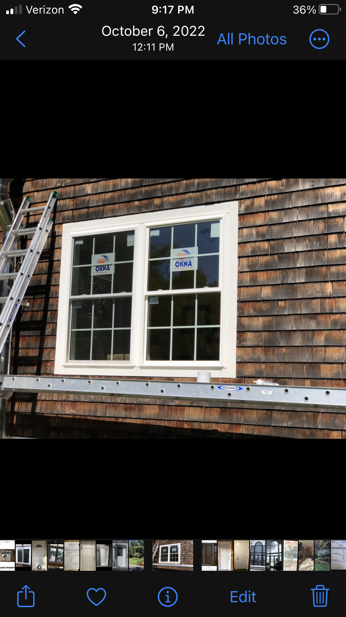 A window is being installed on the side of a house.