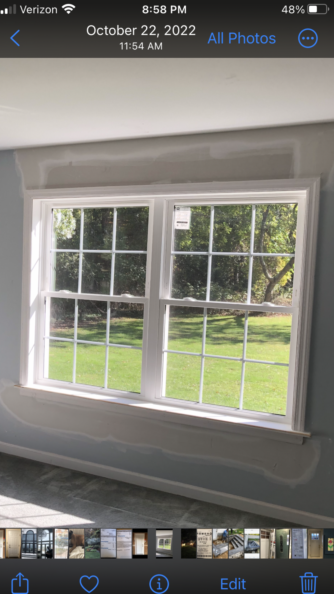 A picture of a window in a room on a cell phone.