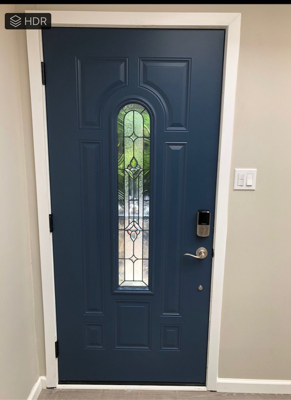 A blue door with a stained glass window