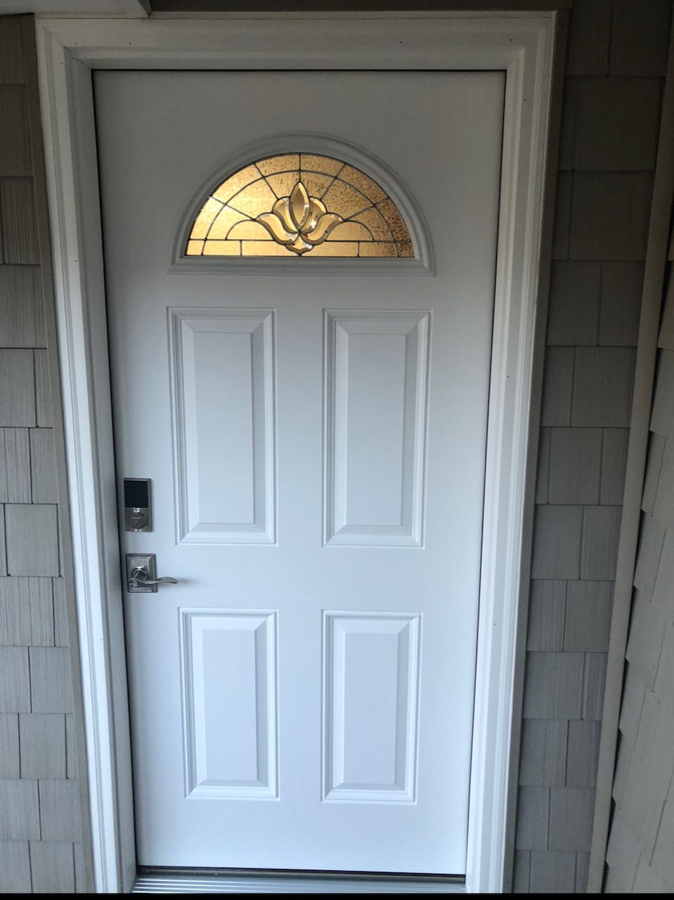 A white door with a stained glass window