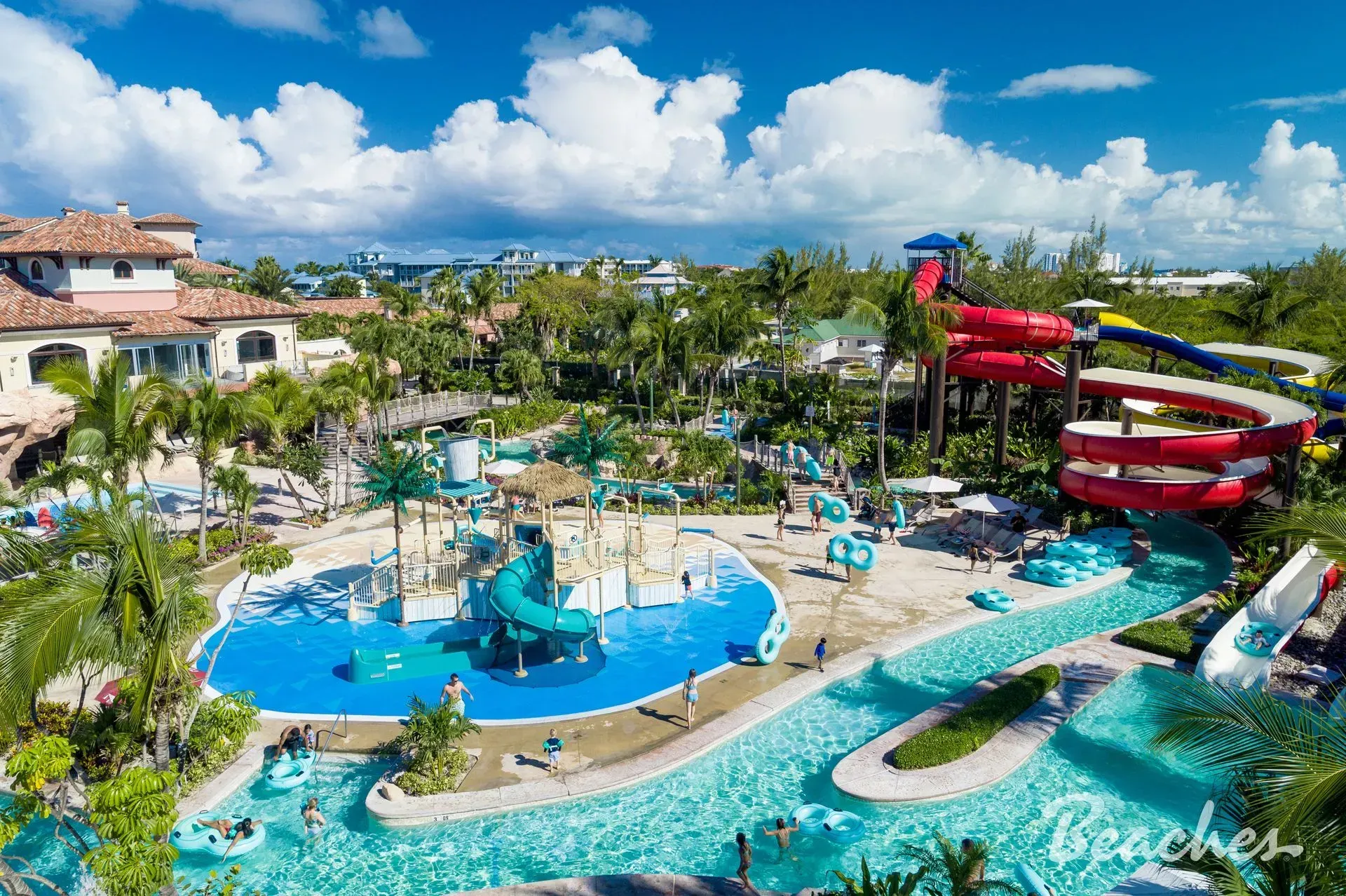 An aerial view of a water park with a large pool and water slides.