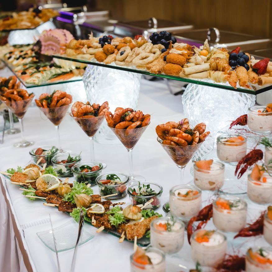 A buffet table filled with lots of food and drinks.