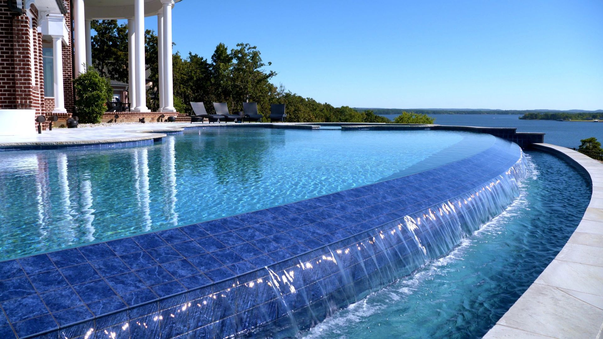 A large swimming pool with a waterfall in the middle