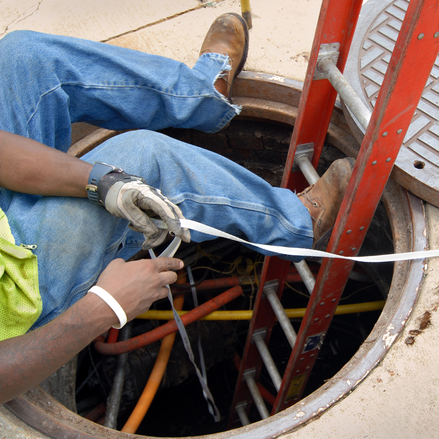 Man Organizing the Cables in A Manhole | Grove City, OH | CST Utilities