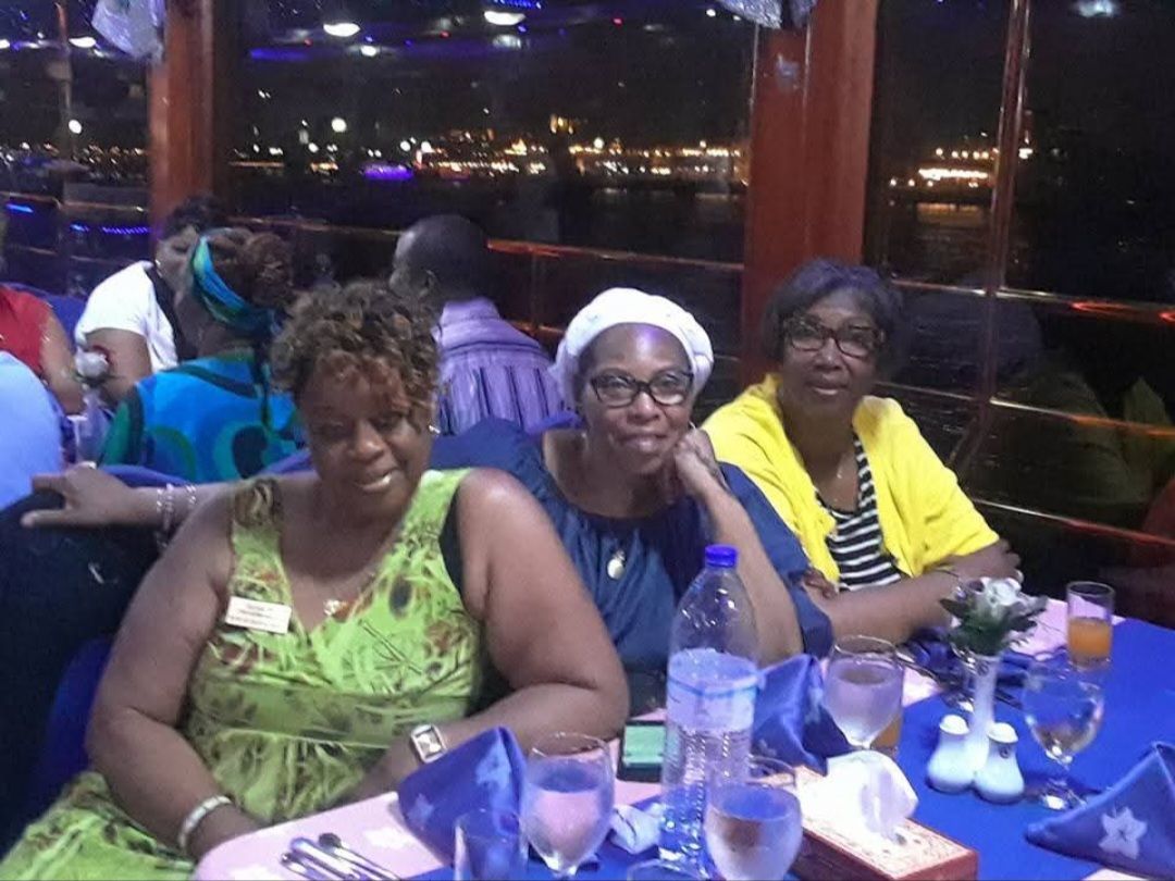 A group of women are sitting at a table with glasses of water
