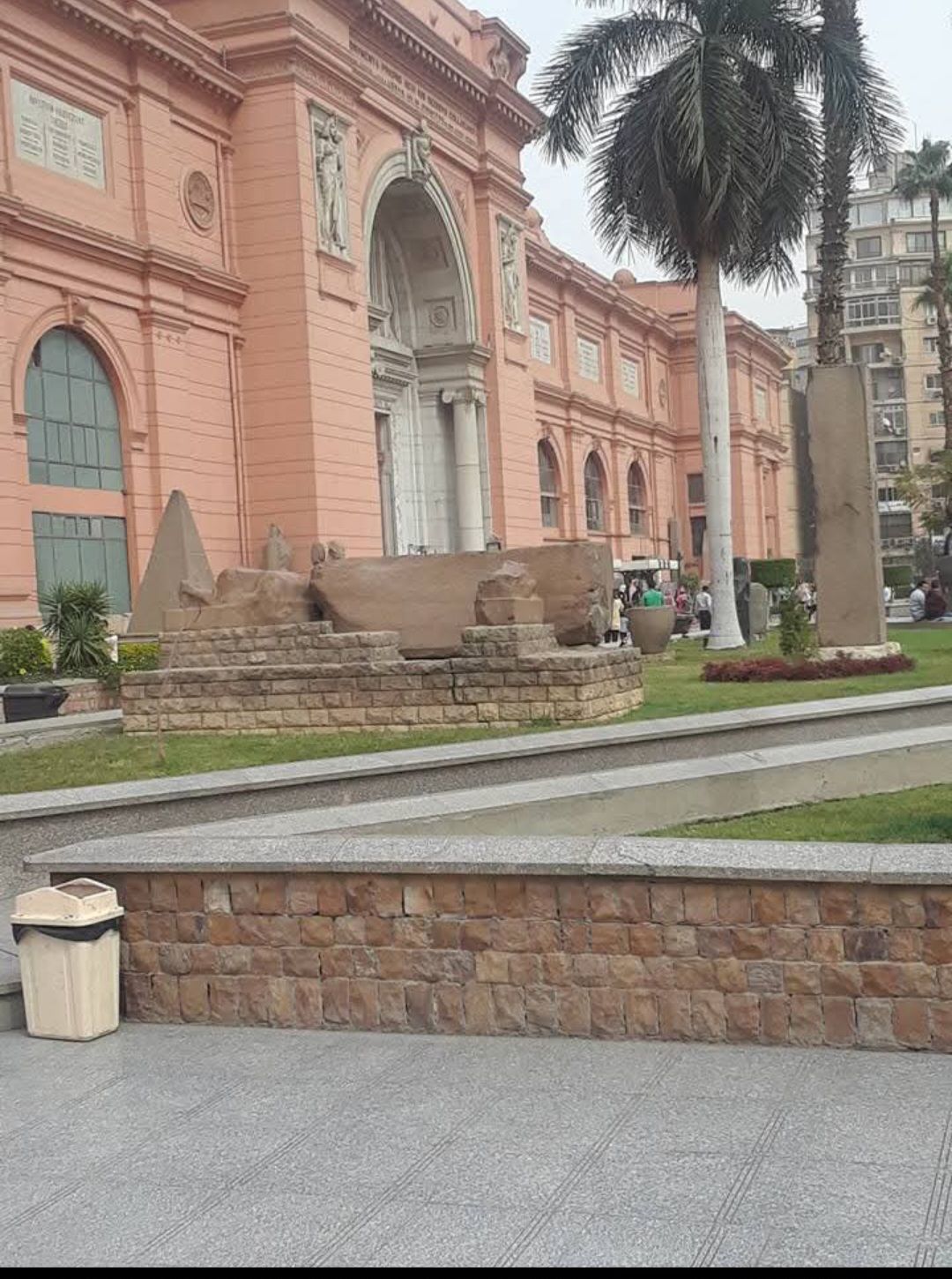 A large building with a palm tree in front of it