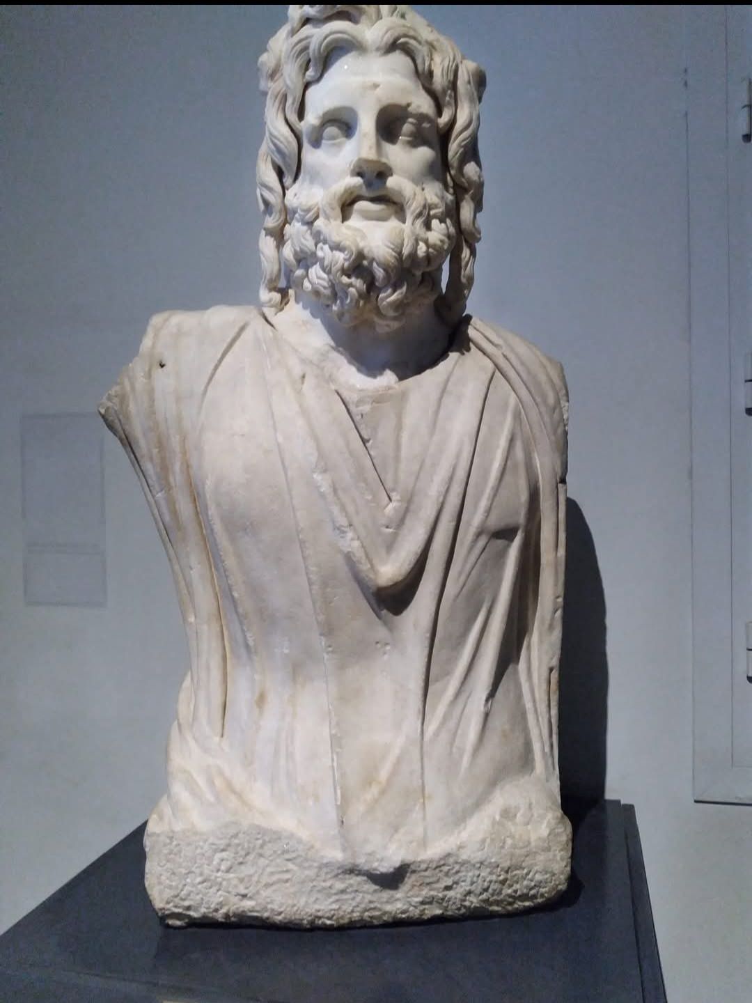 A statue of a man with a beard is on display